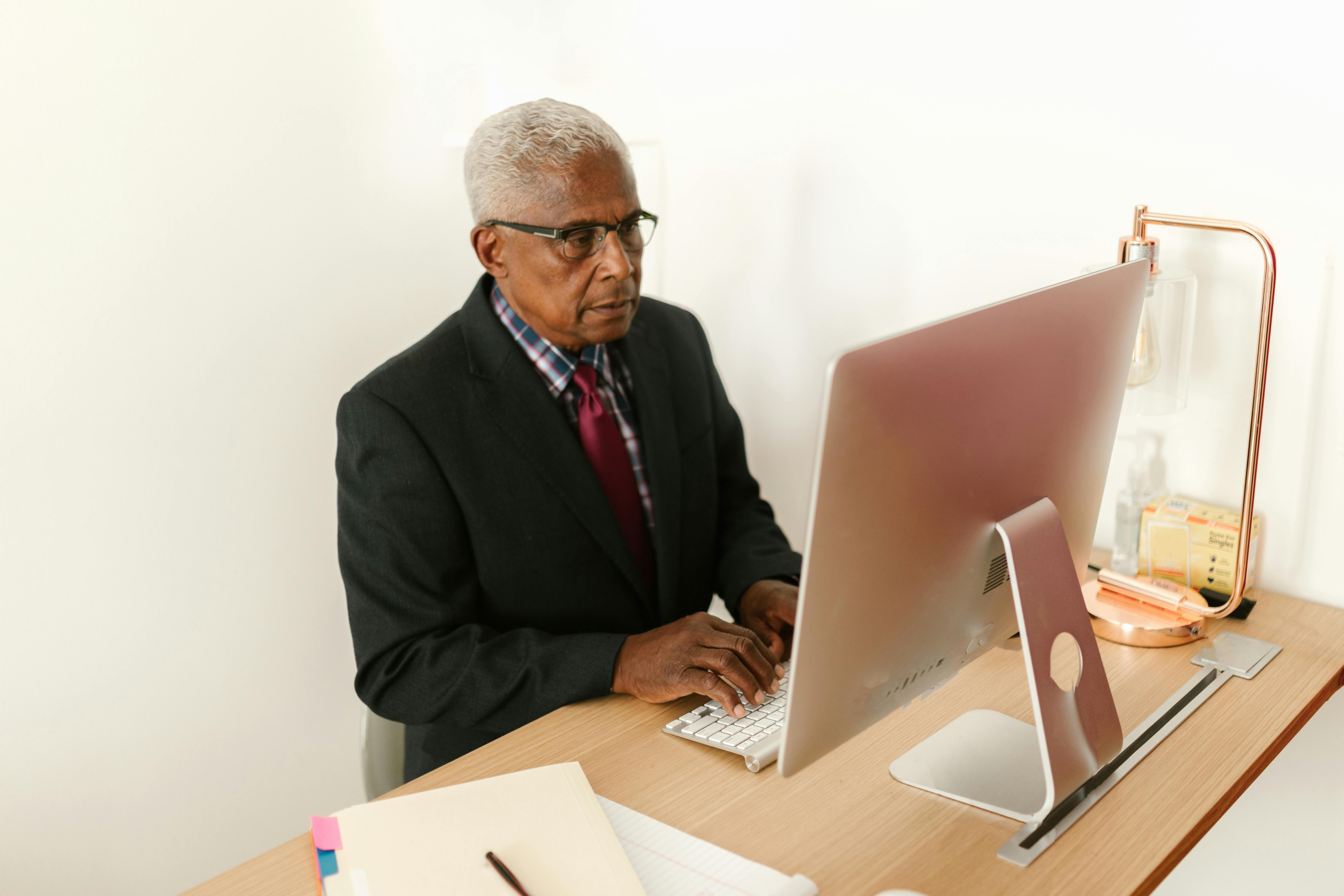 A senior man on a video call from home.